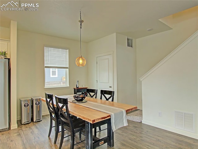 dining space featuring hardwood / wood-style flooring