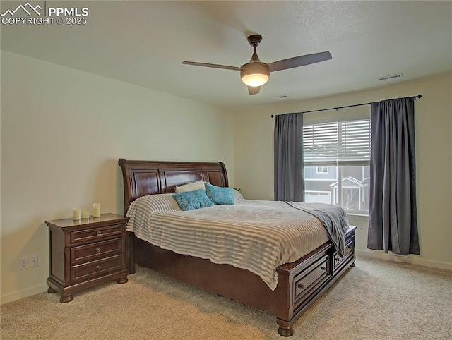 bedroom with ceiling fan and light colored carpet