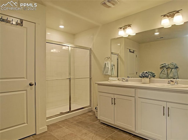 bathroom featuring tile patterned flooring, vanity, and a shower with shower door