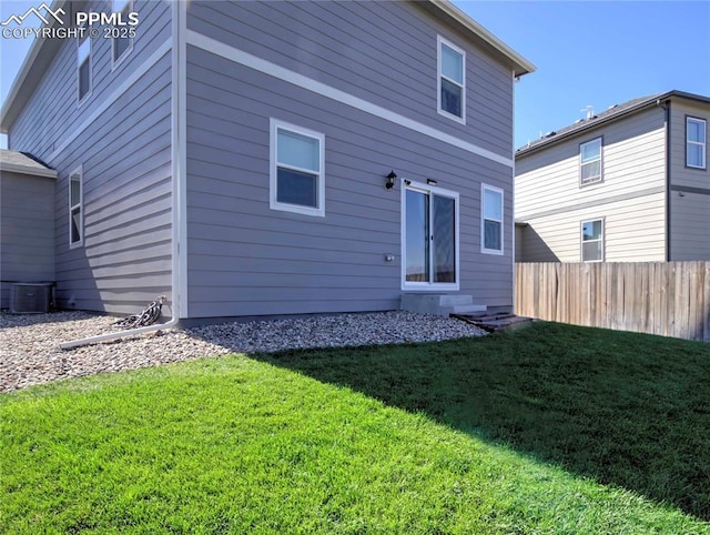 rear view of property with a yard