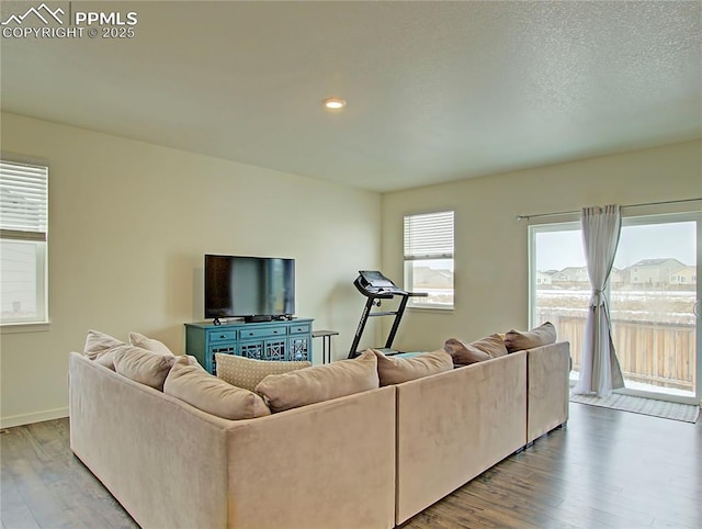 living room with hardwood / wood-style flooring and a textured ceiling