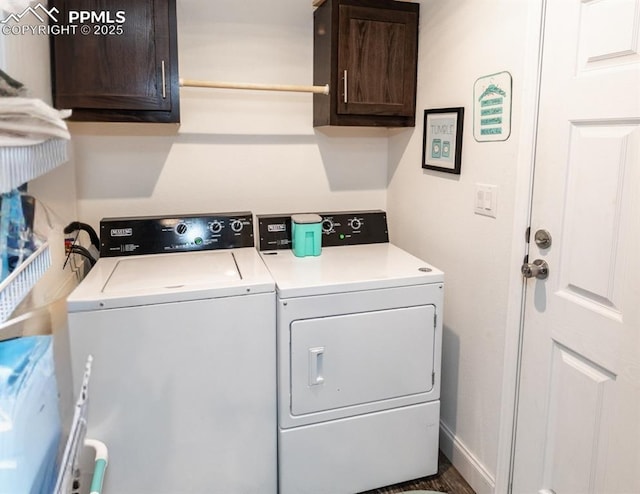 laundry room featuring washing machine and dryer and cabinets