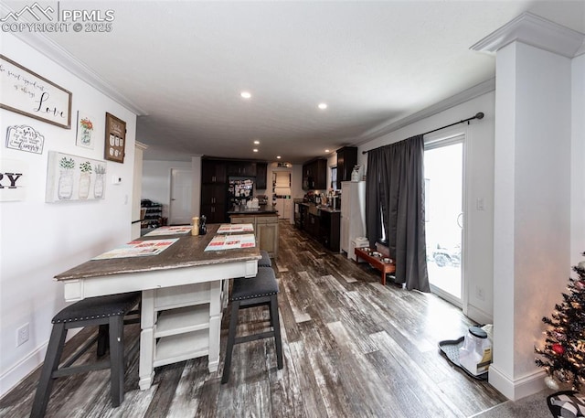 dining space with dark hardwood / wood-style flooring and crown molding