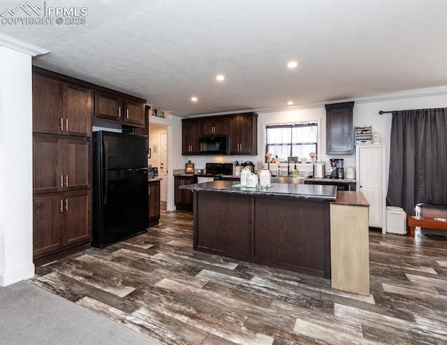 kitchen with a center island, dark wood-type flooring, black appliances, sink, and dark brown cabinets