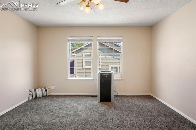 carpeted empty room featuring a textured ceiling and ceiling fan