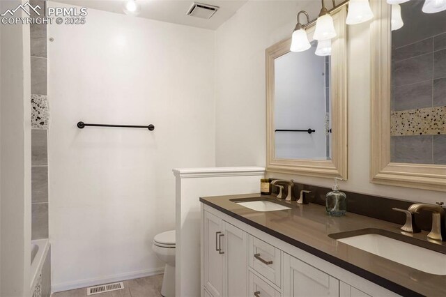 bathroom featuring tile patterned floors, vanity, and toilet