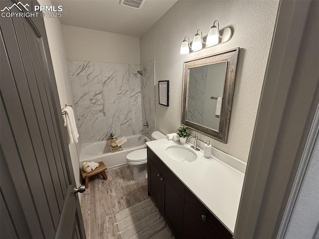 full bathroom featuring vanity, toilet, wood-type flooring, and shower / washtub combination