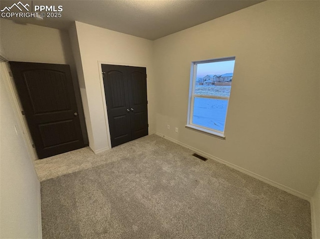 unfurnished bedroom featuring light colored carpet