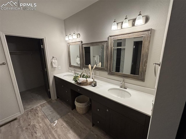 bathroom featuring hardwood / wood-style floors, vanity, and an enclosed shower