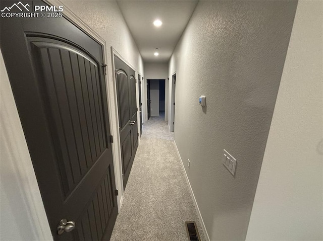 hallway with light colored carpet