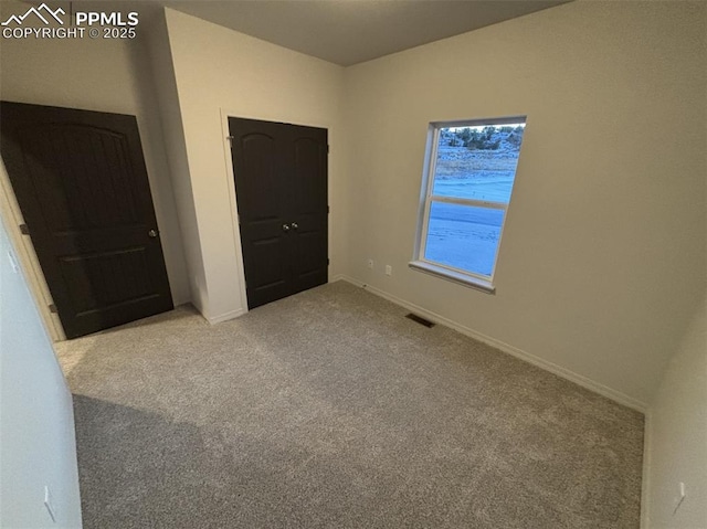 unfurnished bedroom with light colored carpet