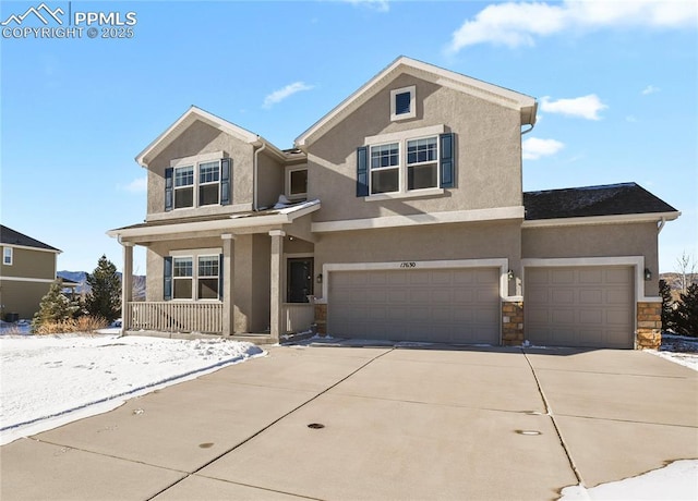 view of front of home with covered porch and a garage