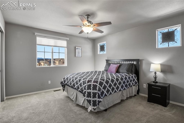 bedroom featuring ceiling fan and carpet