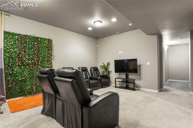 home theater room with a textured ceiling and carpet flooring