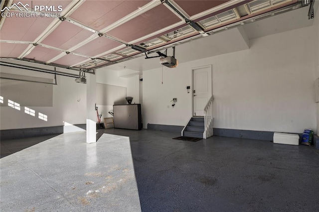 garage featuring a garage door opener and fridge