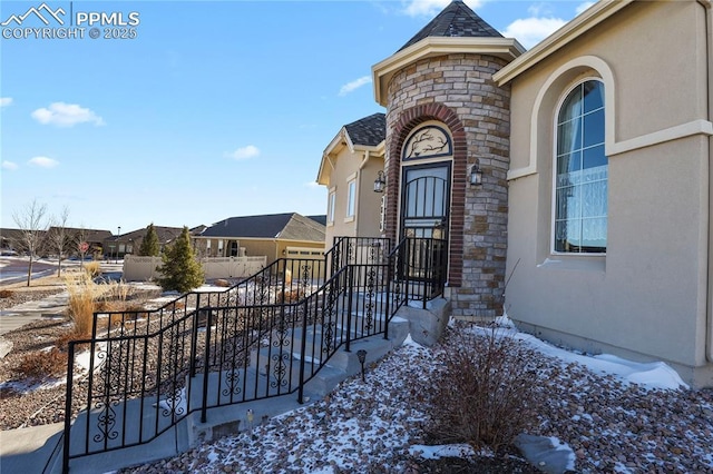 view of snow covered property entrance