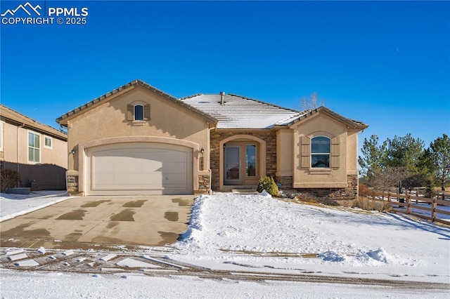 view of front of property featuring french doors and a garage