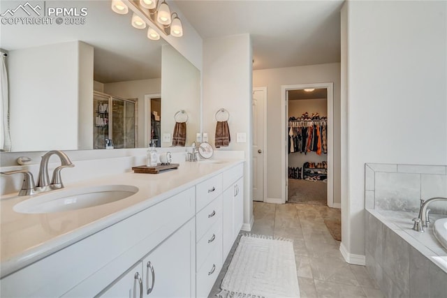 bathroom with tile patterned floors, vanity, and shower with separate bathtub