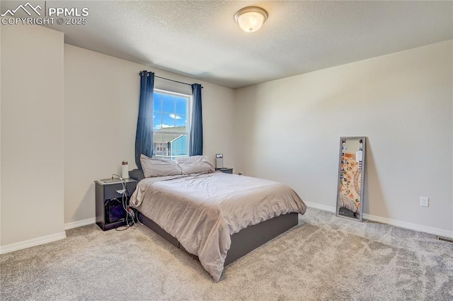 carpeted bedroom featuring a textured ceiling