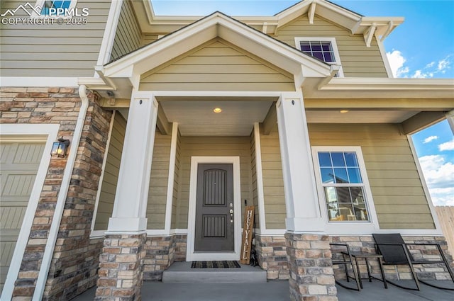 view of exterior entry with covered porch