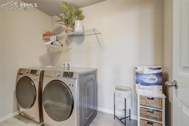 laundry area with light tile patterned floors and independent washer and dryer