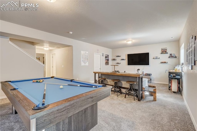 game room with bar area, light carpet, and pool table