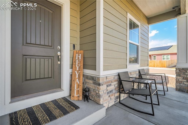 view of exterior entry with covered porch