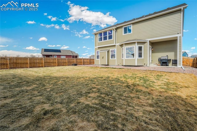 rear view of property with a lawn