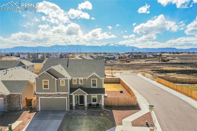 view of front of home with a mountain view and a garage