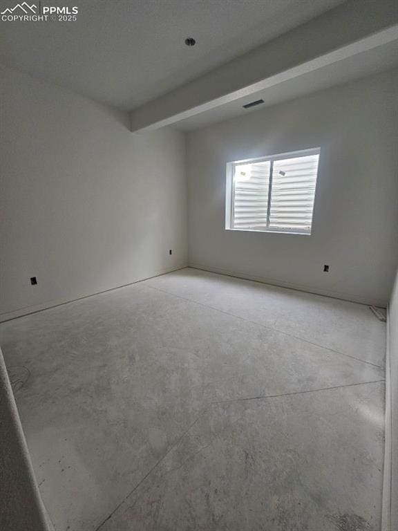 empty room with beamed ceiling