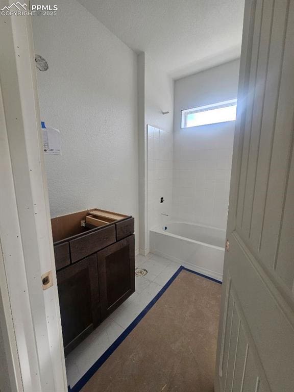 bathroom featuring tile patterned flooring and shower / bath combination