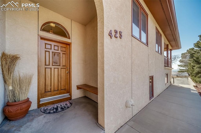 entrance to property featuring stucco siding