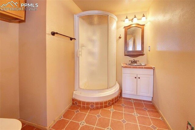 bathroom with vanity, tile patterned floors, and walk in shower