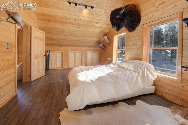 bedroom with wood walls, wooden ceiling, and vaulted ceiling