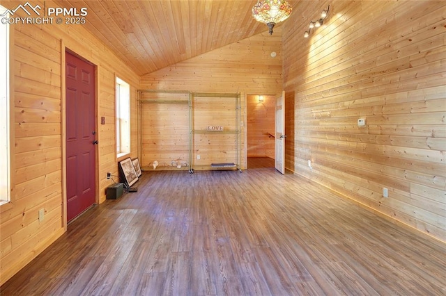 spare room with wood walls, hardwood / wood-style floors, wooden ceiling, and lofted ceiling