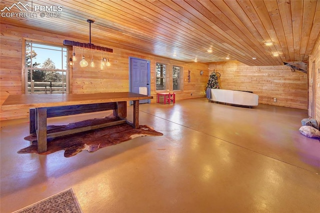 interior space featuring concrete floors, wooden walls, and wood ceiling