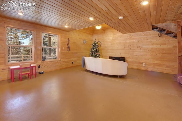 interior space featuring wood ceiling and wood walls