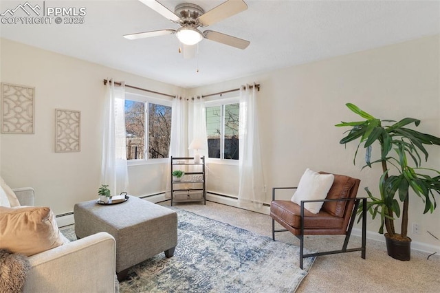 living area with ceiling fan and a baseboard heating unit