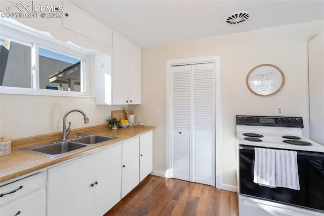 kitchen featuring white cabinetry, sink, electric range, and dark wood-type flooring