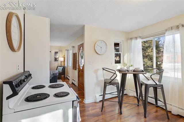 kitchen with white electric range oven, dark hardwood / wood-style floors, and a baseboard heating unit