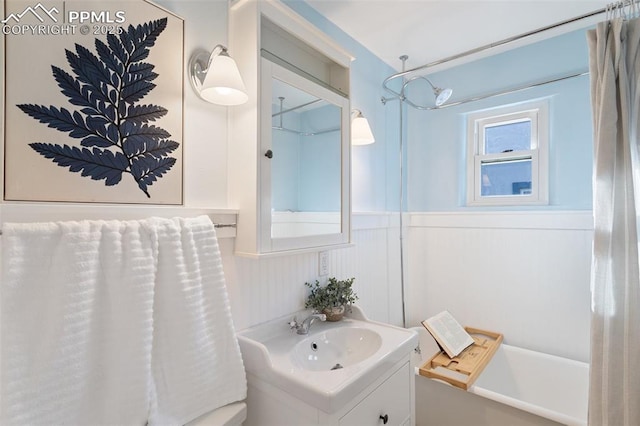 bathroom featuring vanity and wood walls