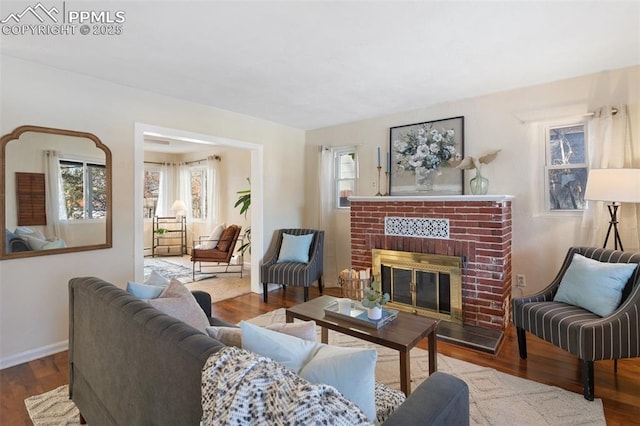 living room featuring plenty of natural light, wood-type flooring, and a fireplace