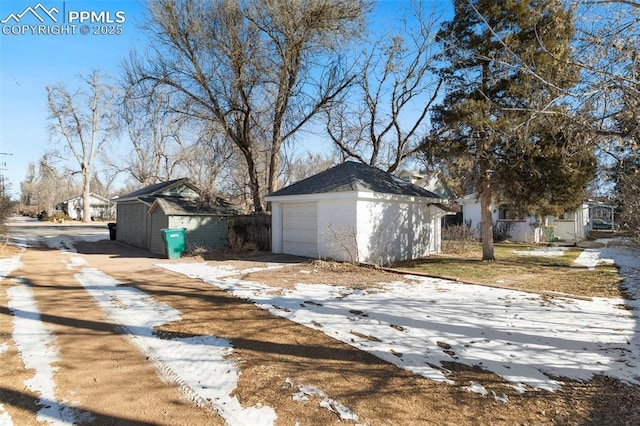 exterior space featuring a garage and an outdoor structure