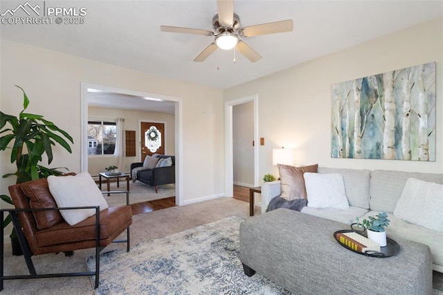 carpeted living room with ceiling fan