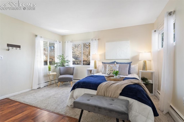 bedroom featuring a baseboard radiator and hardwood / wood-style floors