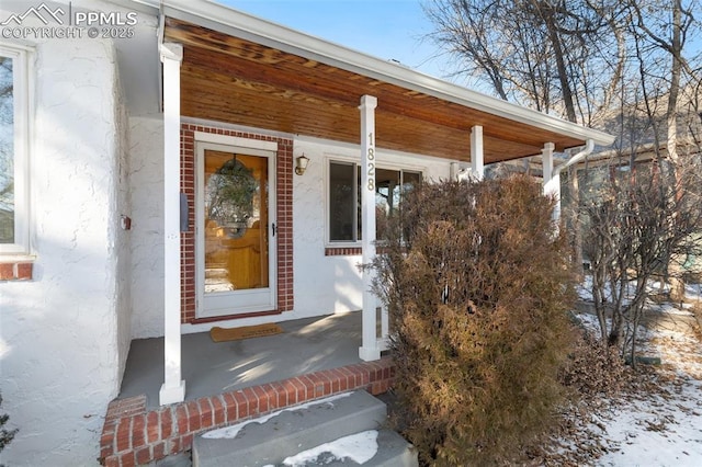 view of snow covered property entrance