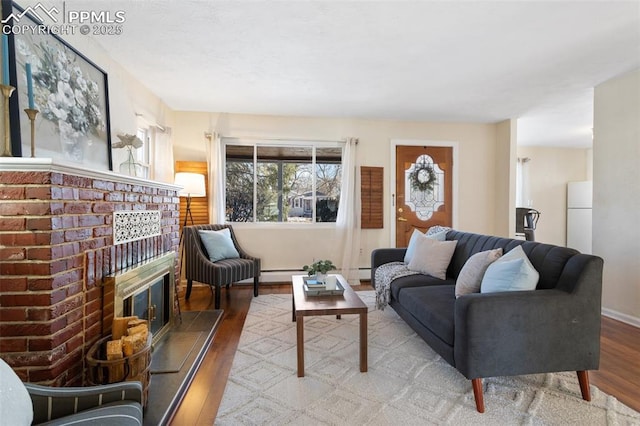 living room featuring baseboard heating, a fireplace, and wood-type flooring