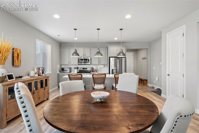 dining area with light hardwood / wood-style floors