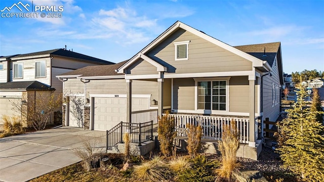 view of front of property featuring a garage and a porch