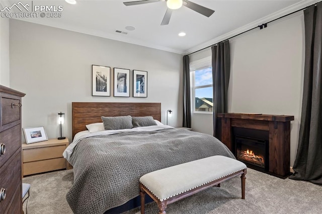 carpeted bedroom featuring ceiling fan and ornamental molding